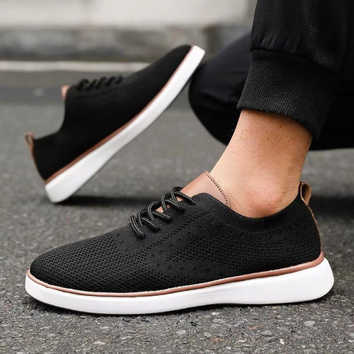 Black lace-up mesh sneakers with white sole and brown trim