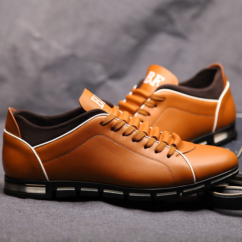 Tan leather low-top lace-up sneakers with white piping and black tread sole