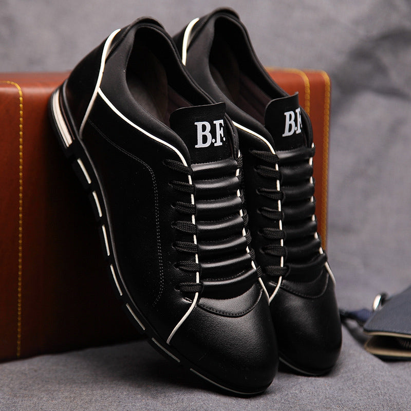 Black leather low-top lace-up sneakers with white piping and chunky tread sole