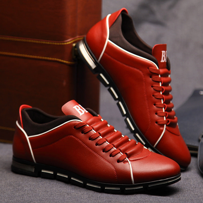 Red leather low-top lace-up sneakers with white piping and black chunky sole