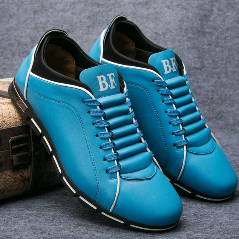 Blue leather low-top lace-up sneakers with white piping and black tread sole