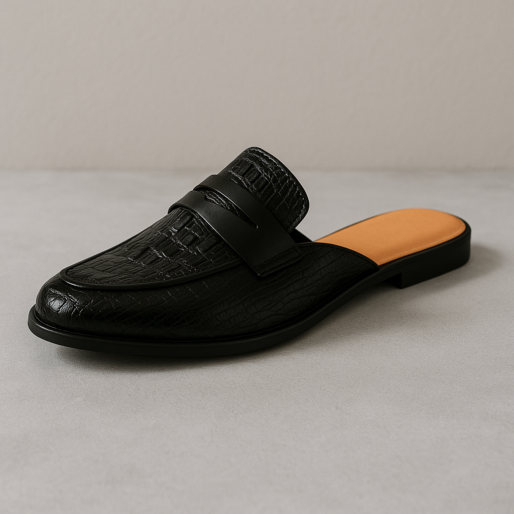Black leather loafer mule, slip-on style with strap detail and textured upper.