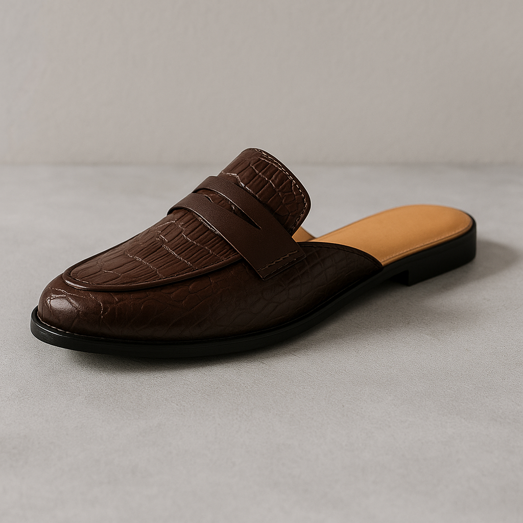 Brown leather loafer mule, slip-on style with strap detail and textured upper.