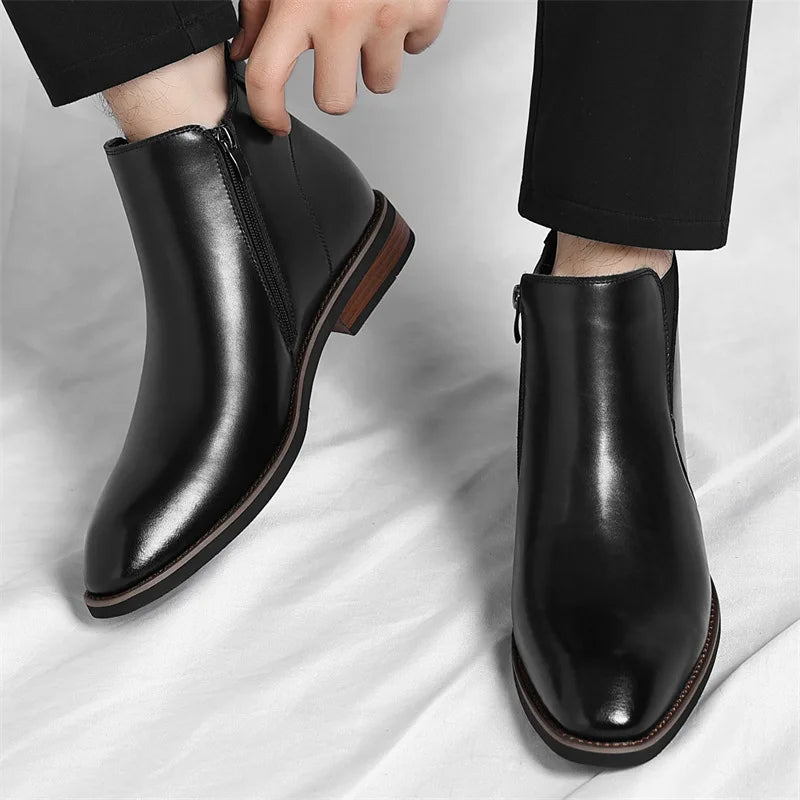 Black Chelsea-style boots with elastic gore, worn with ankle-length pants