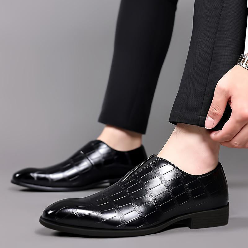 Black croc-texture loafer on foot with low block heel and slip-on fit