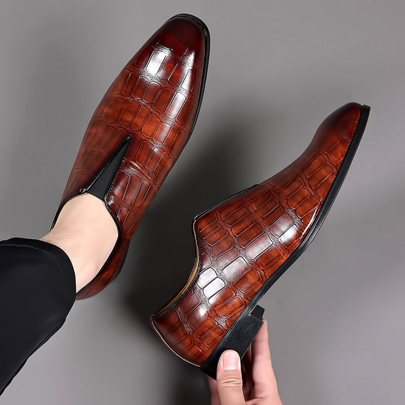 Pair of glossy brown croc-texture loafers with slip-on profile and low block heels