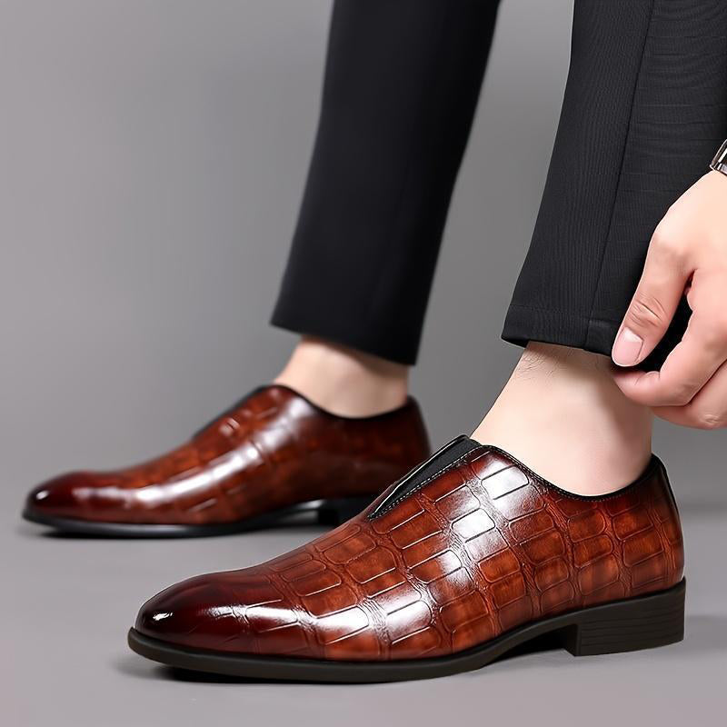 Brown croc-texture loafer on foot with low block heel and slip-on fit
