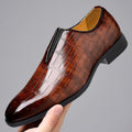 Glossy brown croc-texture loafer with slip-on design and low block heel