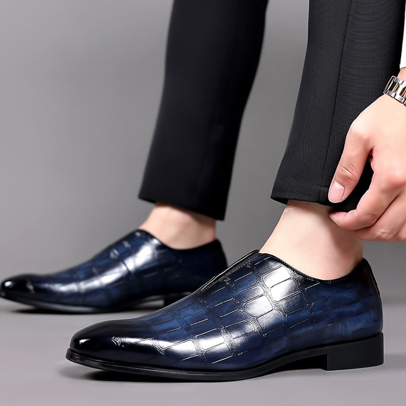 Blue croc-texture loafer on foot with low block heel and slip-on fit
