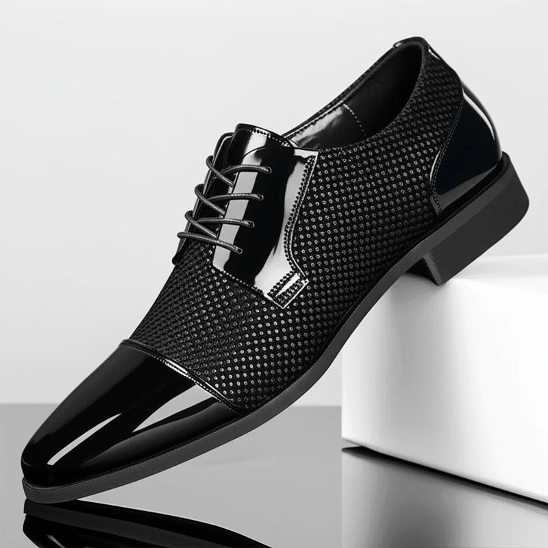 Lace-up dress shoe with black micro-dotted upper, glossy toe panel, and block heel