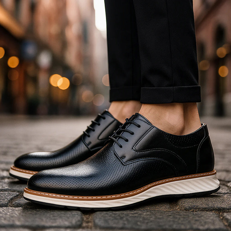 Black lace-up oxford shoes with perforated finish and white sole worn outdoors