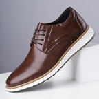 Brown lace-up oxford shoes with perforated finish and white sole, side view