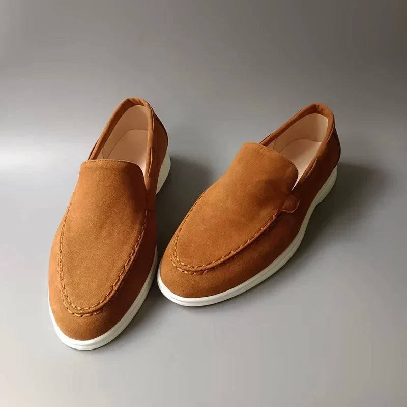 Men's tan suede slip-on loafers, moc toe detailing, white rubber sole