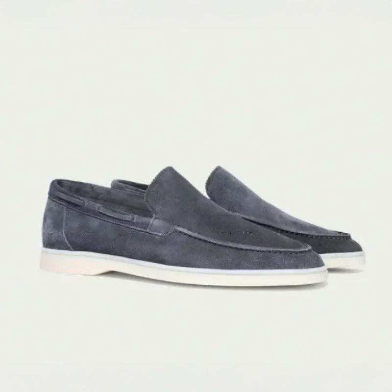 Men's dark gray suede slip-on loafers with moc toe stitching and light sole
