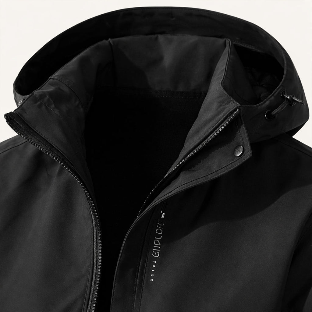 Black hooded jacket close-up with zipper and front storm flap