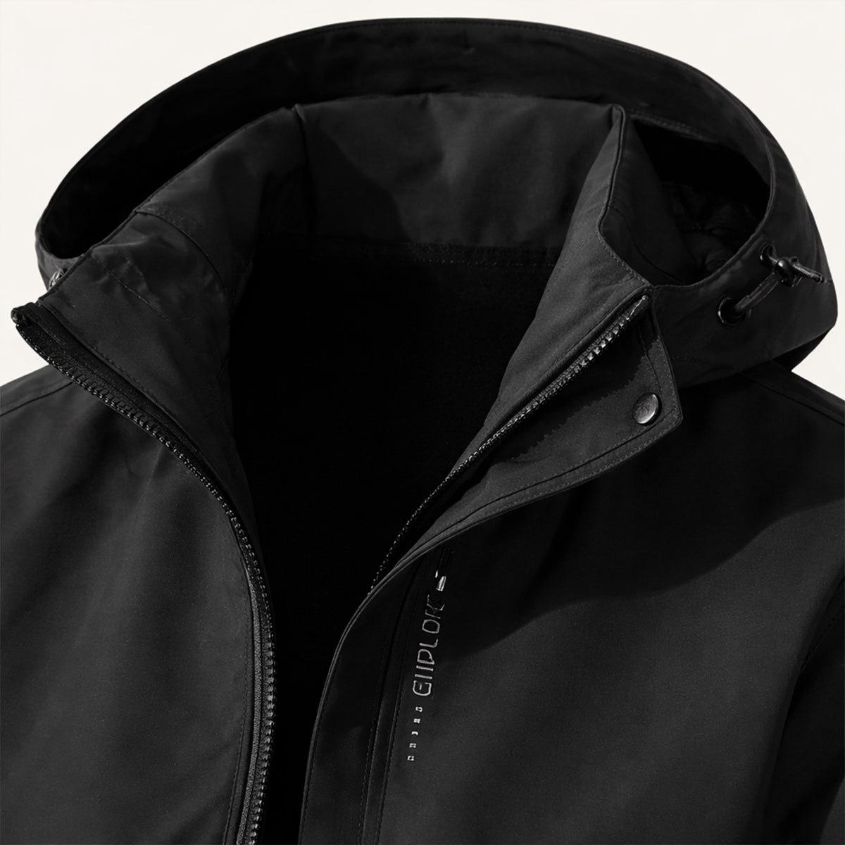 Black hooded jacket close-up with zipper and front storm flap