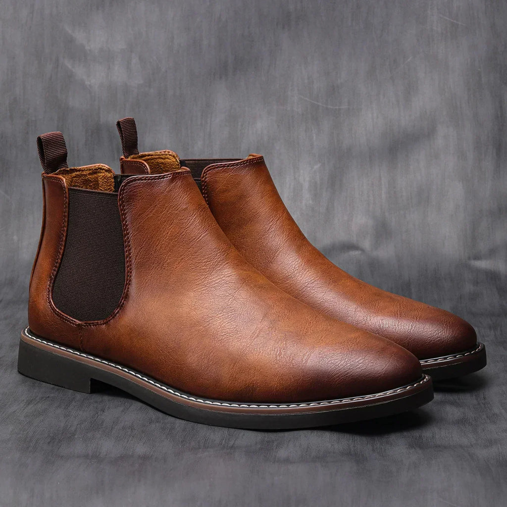 Brown leather chelsea boots with elastic side panels and pull tabs, rounded toe.