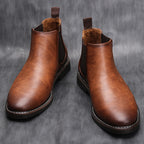 Brown leather chelsea boots with elastic side panels, stitched edges, and pull tabs.