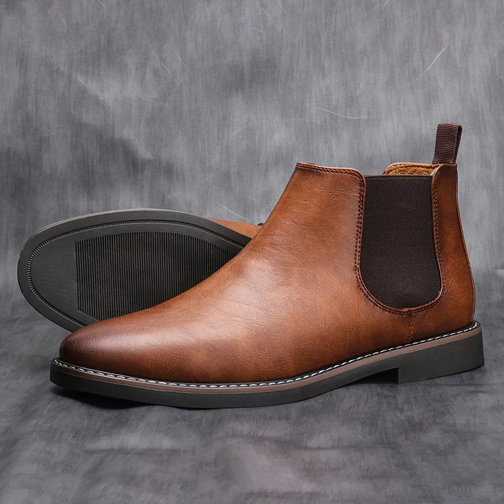 Brown leather chelsea boots with elastic gore and textured rubber outsole, side view.