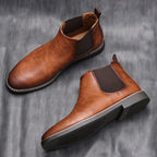 Cognac leather chelsea boots with elastic side panels and padded collar, two views.
