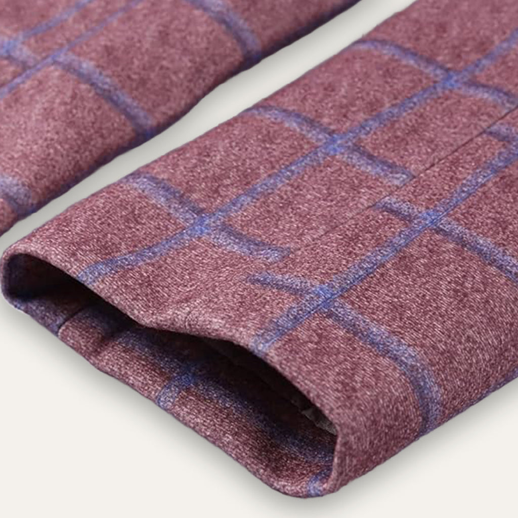 Burgundy plaid blazer fabric fold with visible sleeve cuff and textured weave