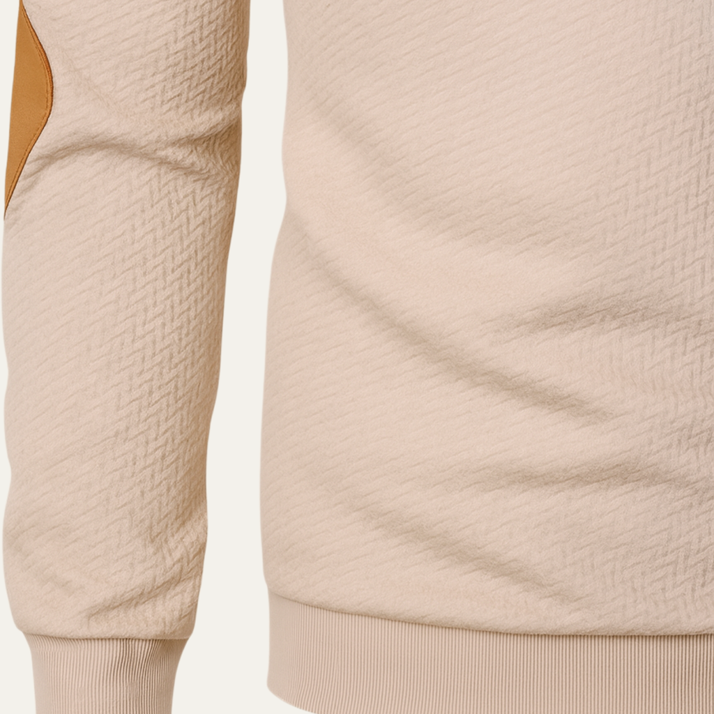 Beige quarter-zip sweater sleeve and ribbed hem detail