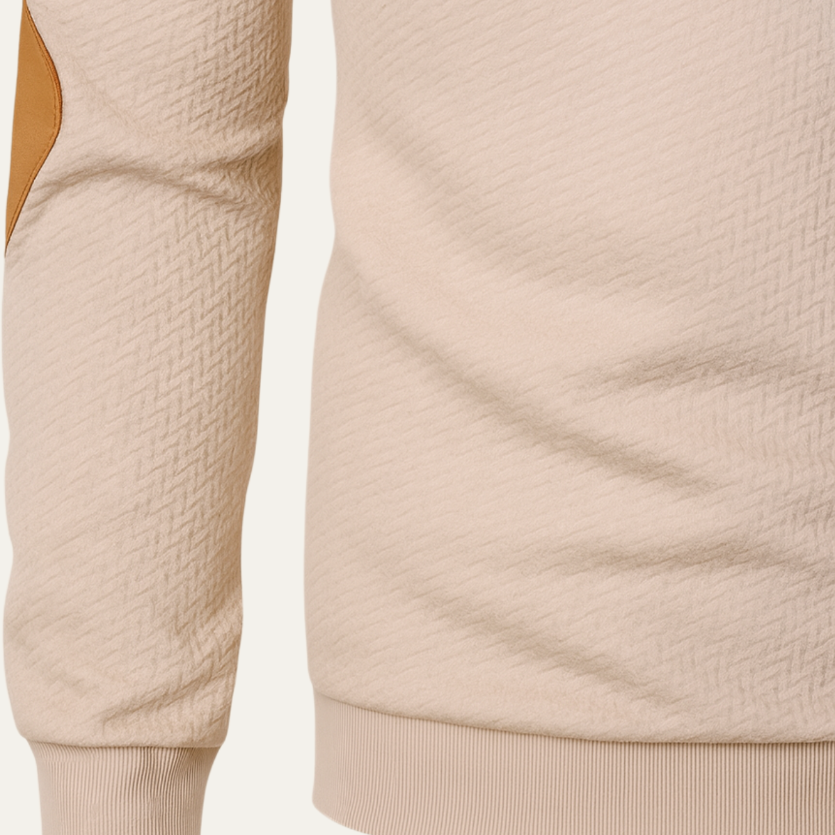 Beige quarter-zip sweater sleeve and ribbed hem detail