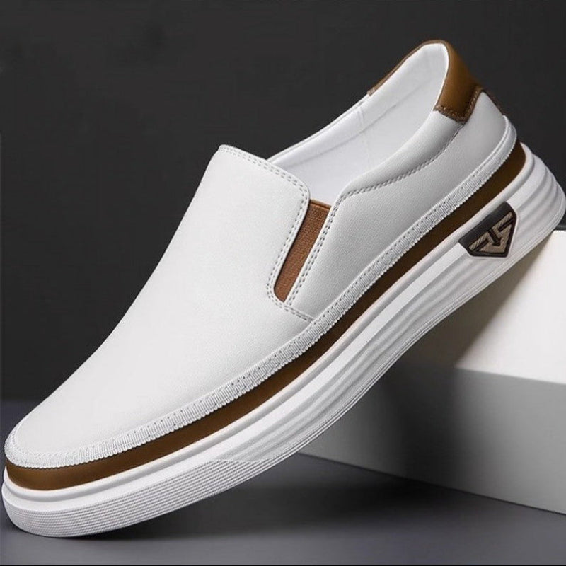 White leather low-top slip-on shoes with brown heel lining and white striped sole
