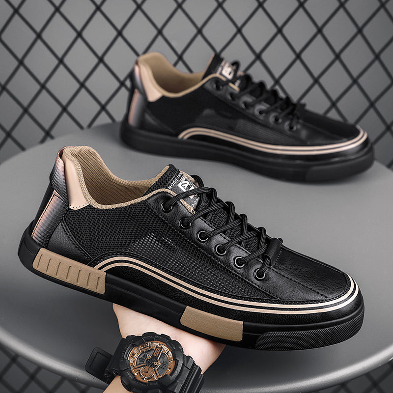 Black low-top mesh sneakers with lace-up front, contrast trim, and beige sole