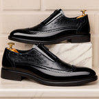 Ostrich dress shoes with glossy black finish, strap buckle, brogue stitching, low block heel