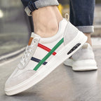 Beige genuine leather retro sneakers on foot with multicolor side stripe
