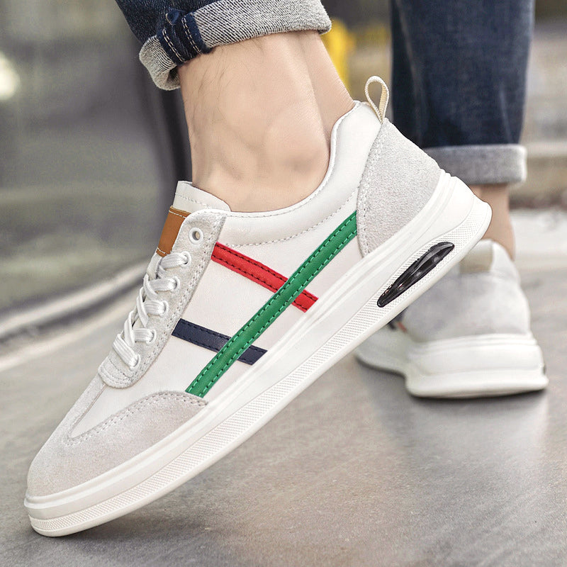 Beige genuine leather retro sneakers on foot with multicolor side stripe