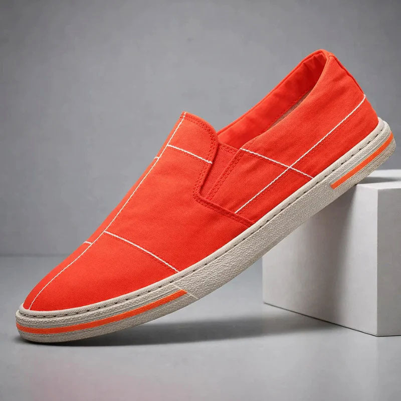 Red slip-on canvas shoe with stitched cross panels and textured rubber sole