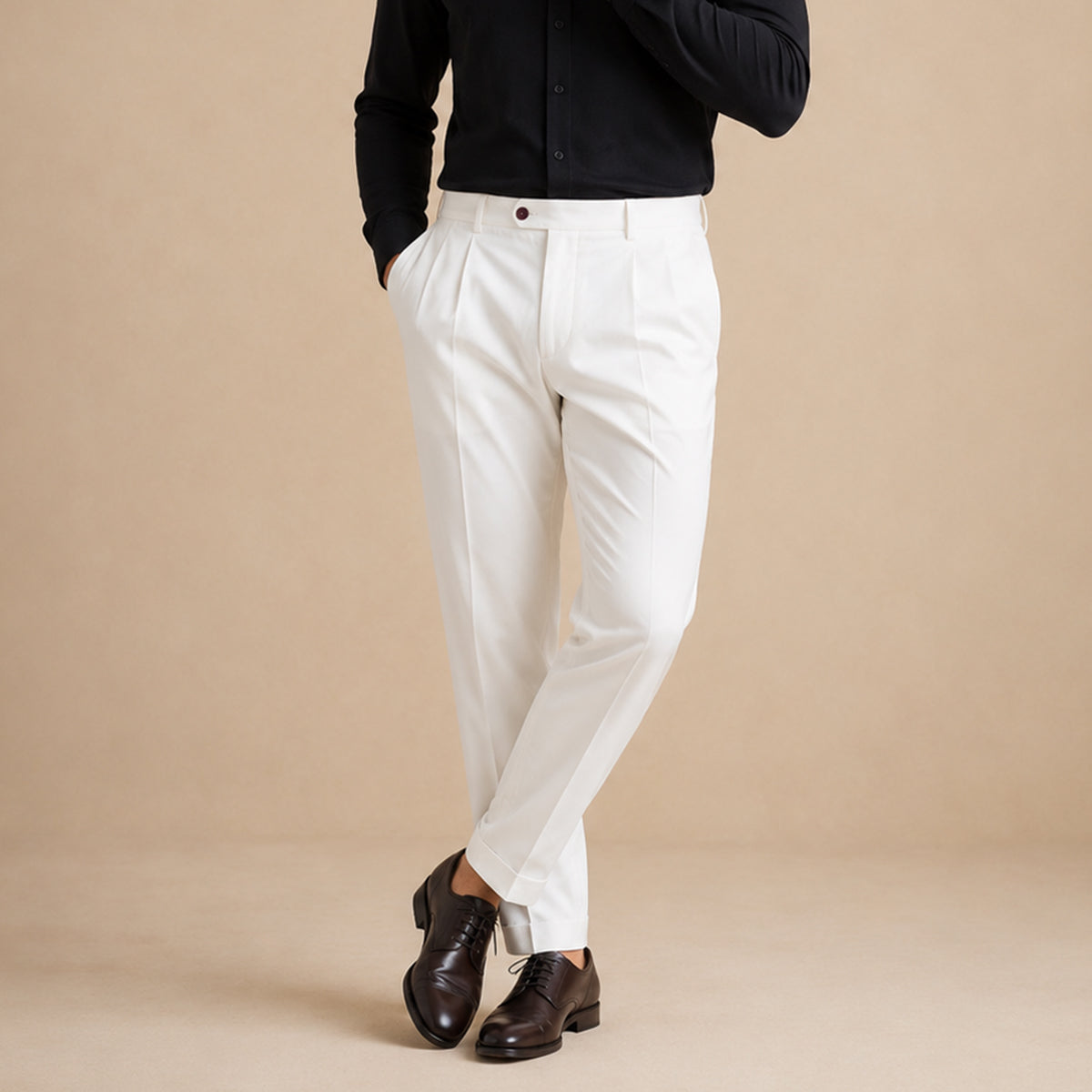 Men’s white classic-fit dress pants on model with pleats, belt loops, and hem