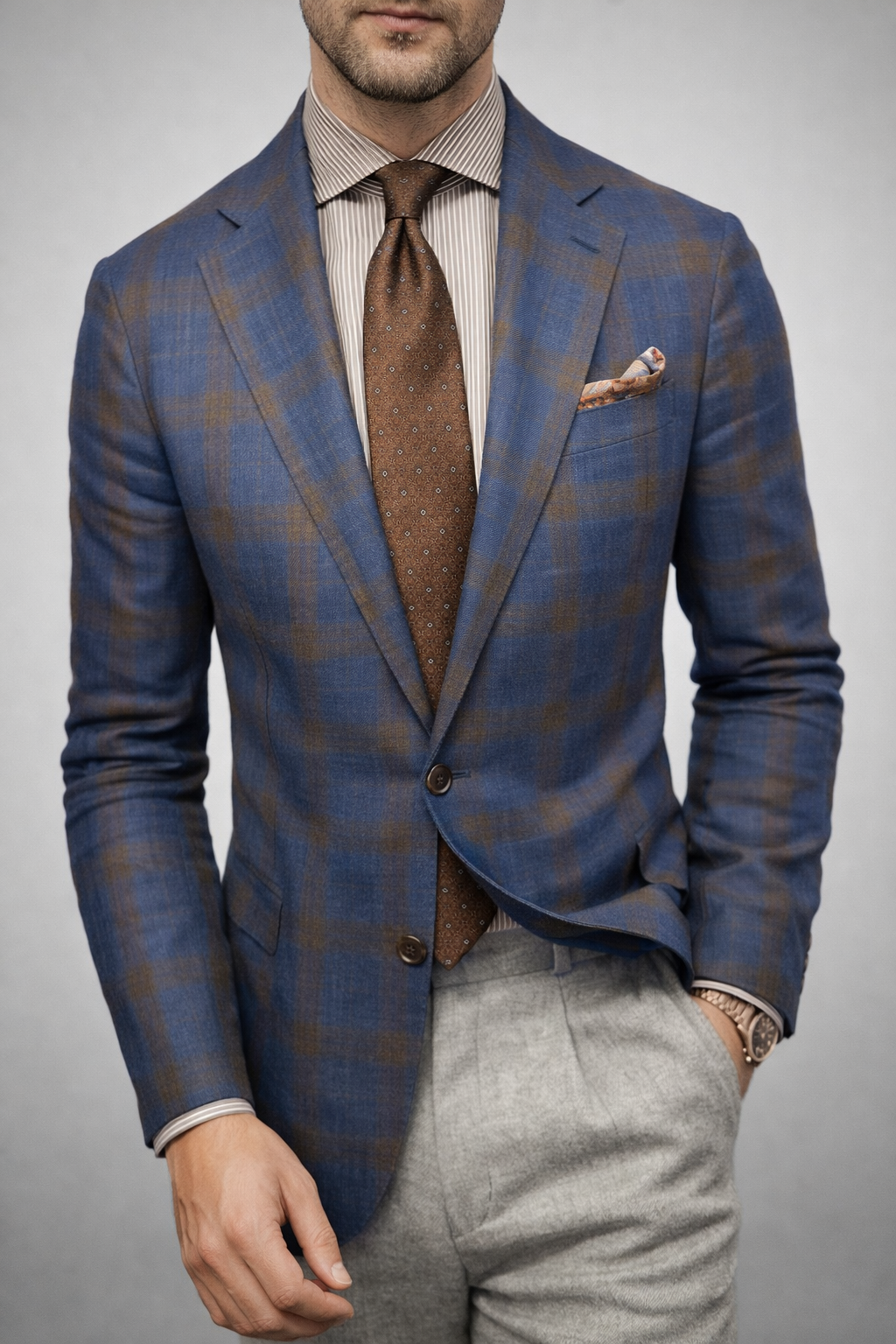 Blue plaid double-breasted blazer with pocket square, patterned tie, and button front