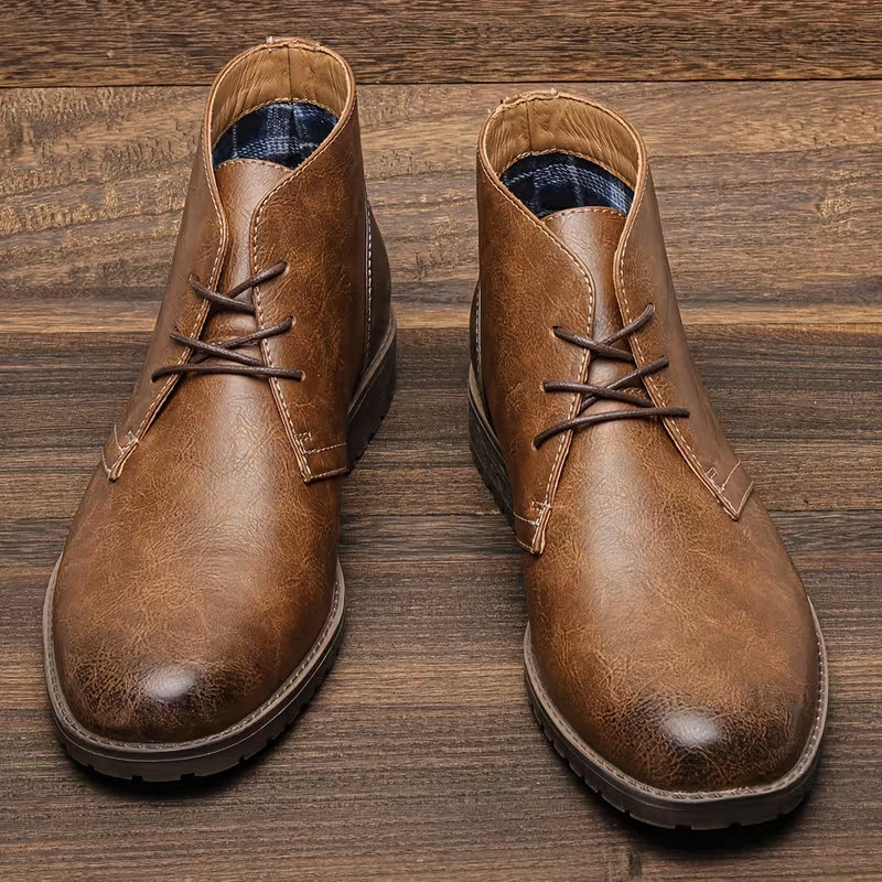 Pair of brown lace-up chukka boots with cushioned lining and textured rubber sole