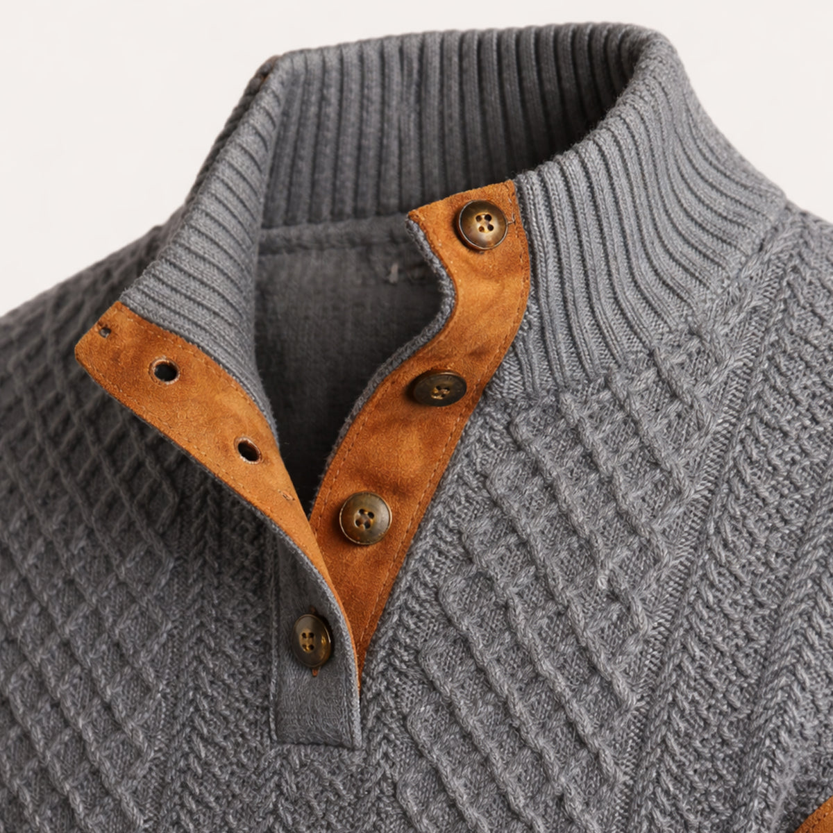Dark gray knit sweater close-up: orange quarter-zip placket with buttons