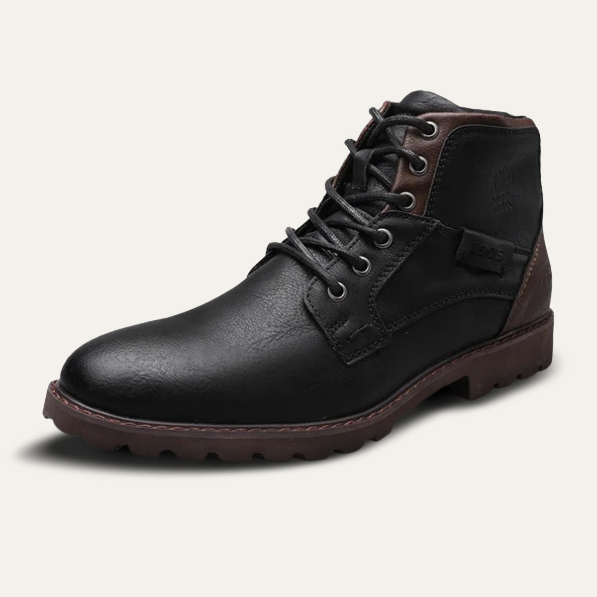 Black leather combat boots with lace-up front, ankle patch detail, and thick tread outsole