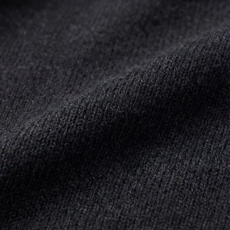 Dark gray knit sweater fabric texture, close-up of fine ribbed knit.