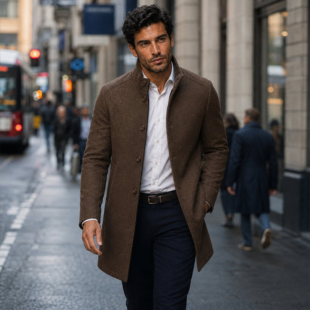 Brown wool overcoat on model with stand collar, button front, and long straight silhouette.