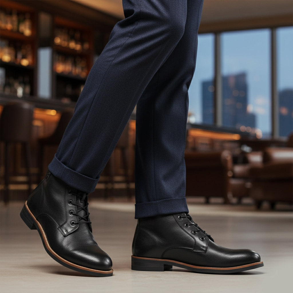 Men's black lace-up ankle boots with low block heel worn with dark suit trousers