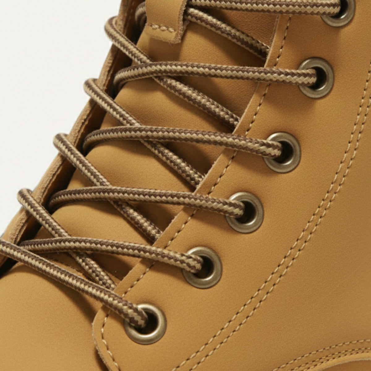 Men’s tan lace-up snow boot with metal eyelets and reinforced seam details