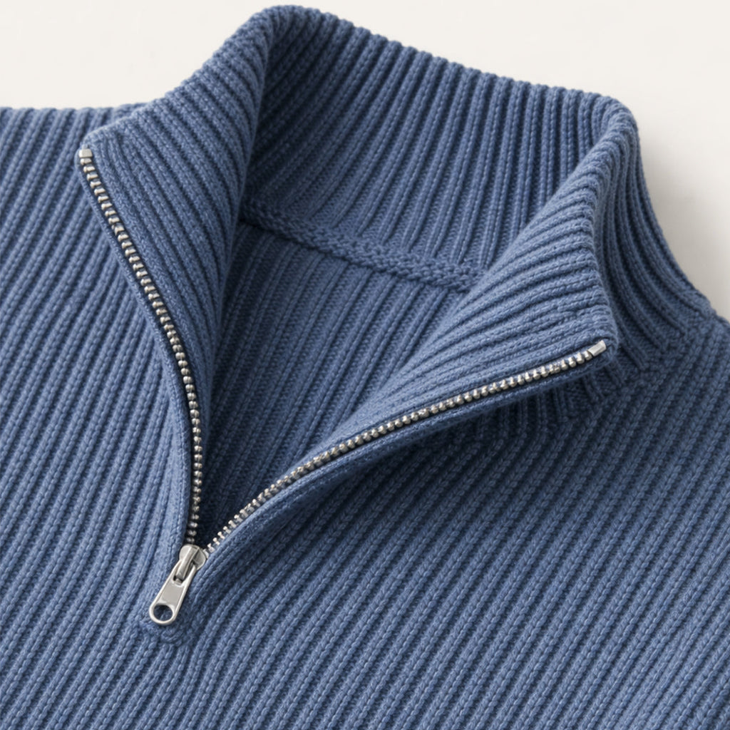 Navy blue half-zip sweater detail with metal zipper and ribbed collar