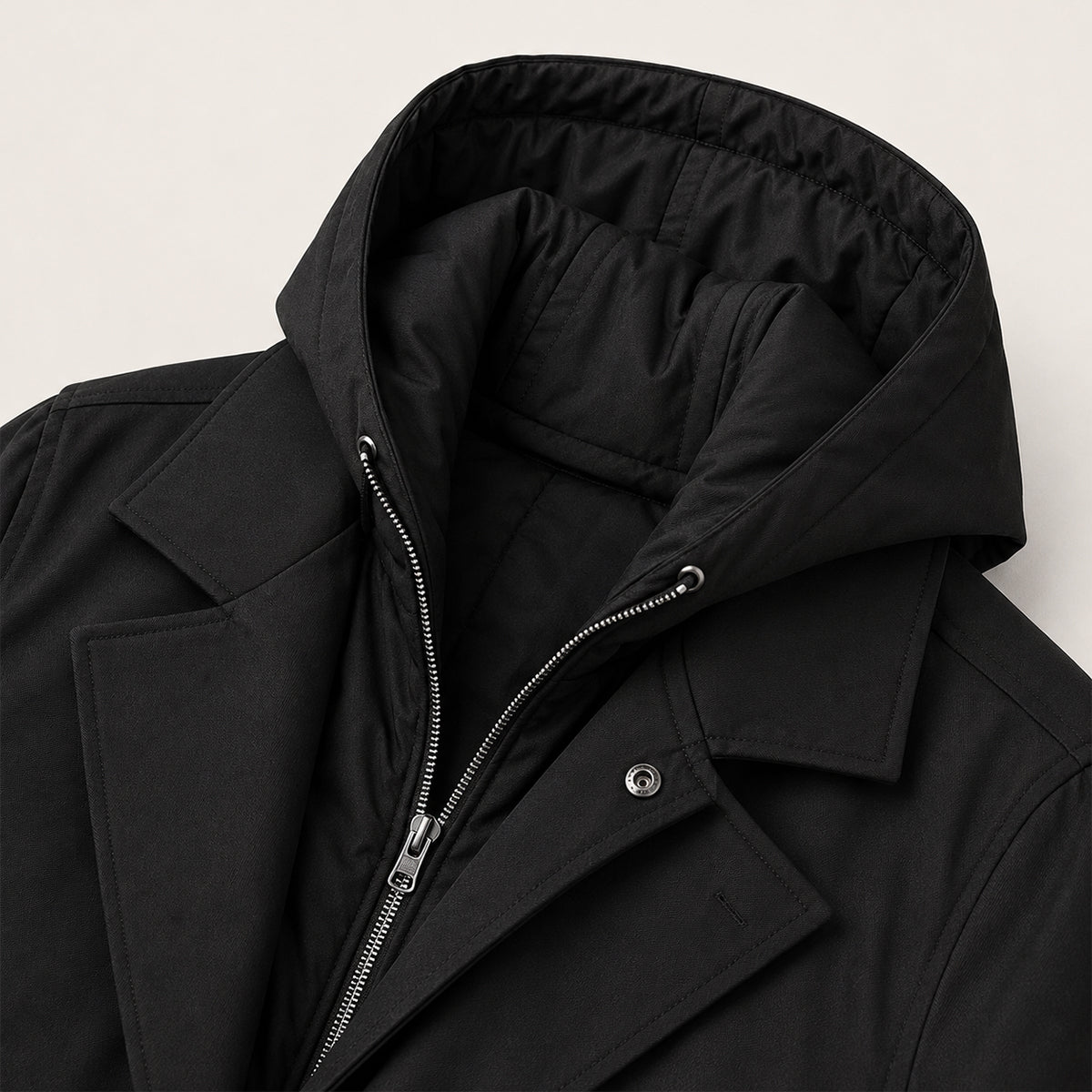 Men's black hooded parka close-up with inner quilted lining and zip-up hood