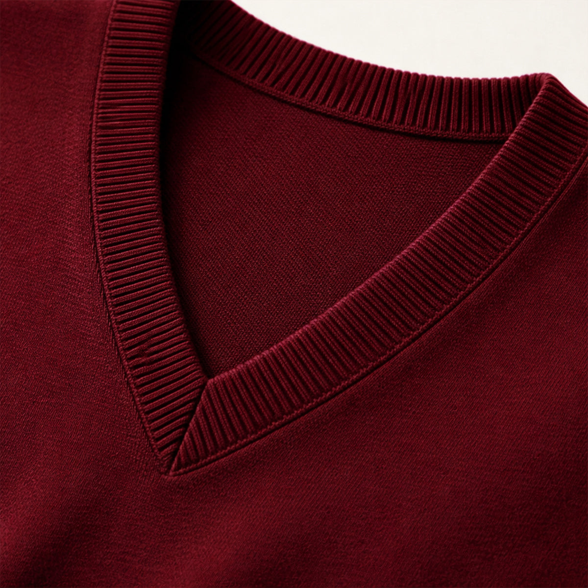 Dark red knit V-neck sweater vest with ribbed neckline and seam detail