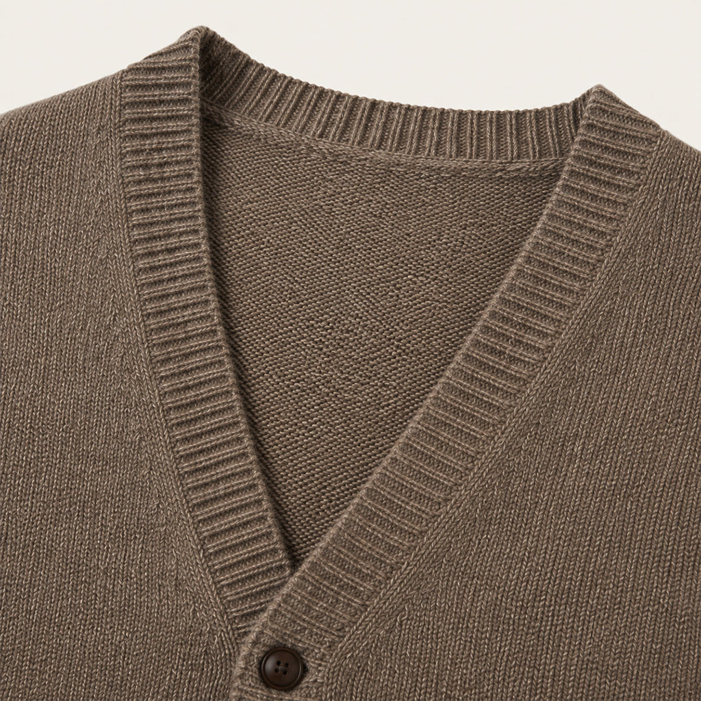 Brown knit vest front close-up: V-neck, button placket, and ribbed edges