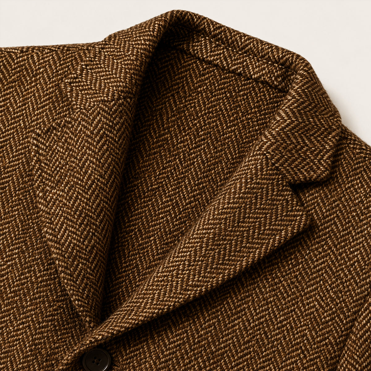 Dark brown tweed blazer close-up of textured fabric and inner lining