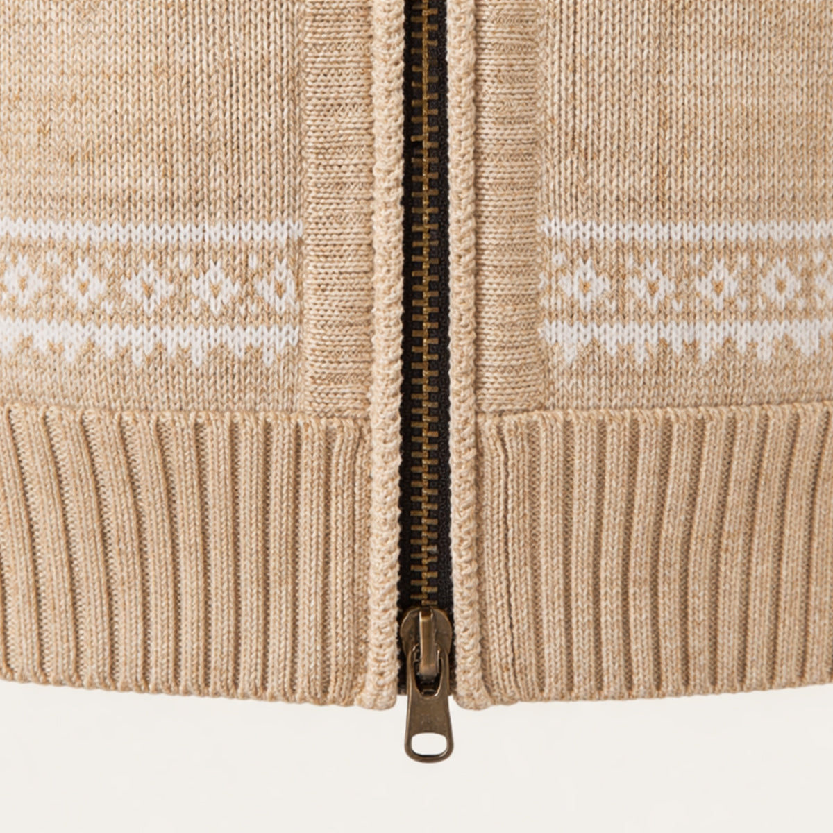 Beige knitted cardigan front close-up with metal zip and ribbed cuff details