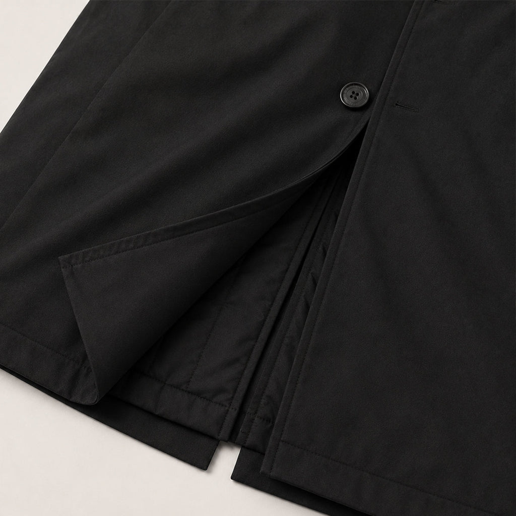 Men's black parka cuff and front flap pocket detail with button closure