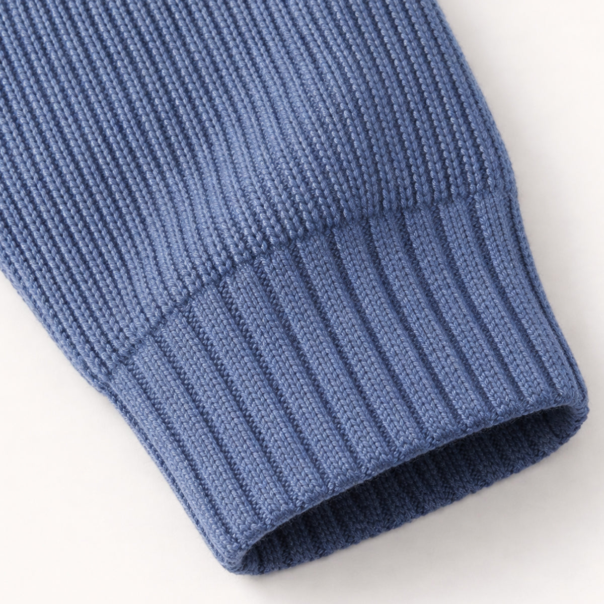 Navy blue ribbed-knit cuff and hem on a half-zip cashmere sweater